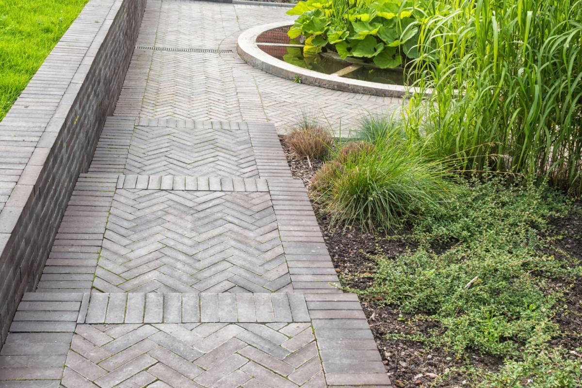 intricate herringbone brick pattern backyard walkway