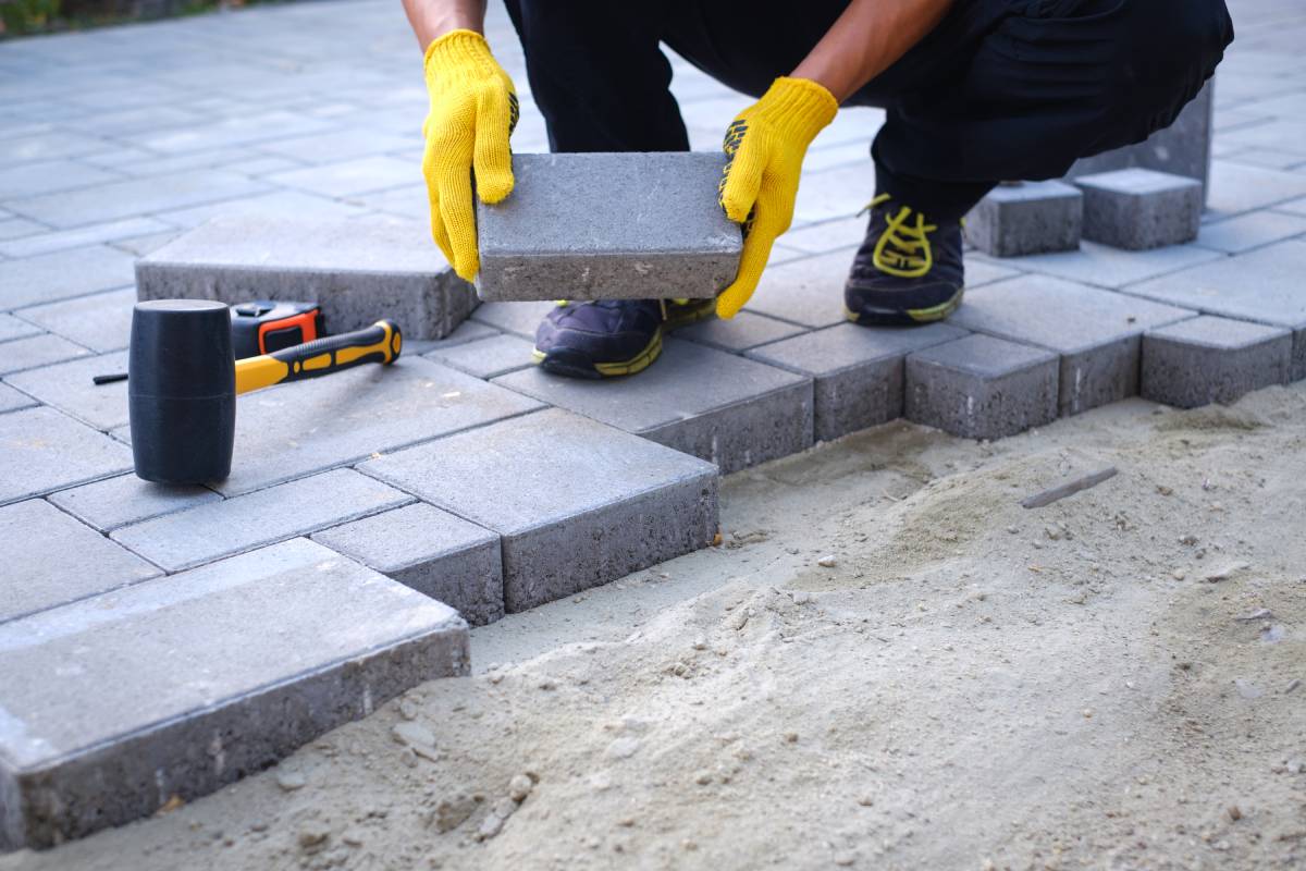 contractor installing brick stone patio